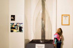 1992 a child staring up at the World's Largest Glass Bottle on display in the Museum of American Glass