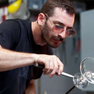 Medium shot of Alexander Rosenberg carefully creating a glass goblet