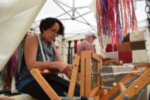 Pauletta Berger doing a weaving demonstration at the Festival of Fine Craft