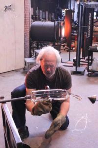 Donald Lipski works on glass piece