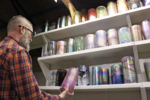 Virgil Marti holding a glass cylinder