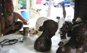 Sibylle Peretii working on head sculptures