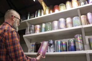 Artist Virgil Marti Holding Glass Cylinder