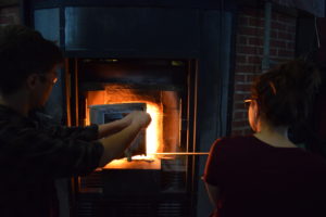 fellows Alexandra Lozier and Carmichael Jones at the hot glass furnace.