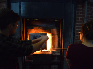 fellows Alexandra Lozier and Carmichael Jones at the hot glass furnace.