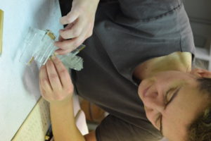 Closeup of Gulfidan Ozmen working on a piece of unseen glass art.