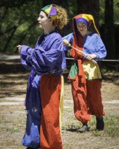 Colorful jesters playing with bubbles at the Fantasy Faire