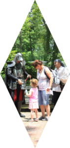 Diamond cutout graphic of man in armor interacting with an adult and child at Fantasy Faire