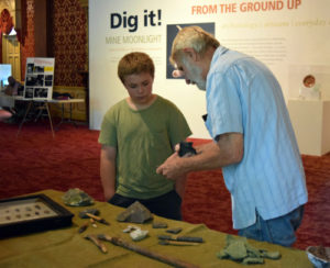 Pair observing Native American Artifacts found in "Dig"