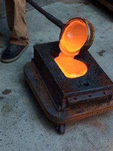 Molten metal being poured into mold