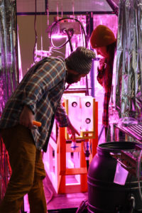 Robert and Sarah Beck installing their piece "To Fetch A Pail of Water" for the Symbiotic Spheres exhibit.