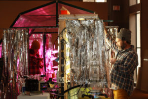 Robert and Sarah Beck installing their piece "To Fetch A Pail of Water" for the Symbiotic Spheres exhibit.