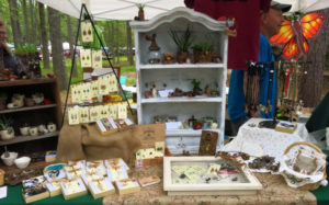 Tupper's Perch booth with various objects such as jewelry and small pots at the ECO Fair