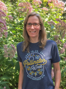 Medium shot of Heather Holm in front of pink flowers. Keynote Speaker at ECOFair,