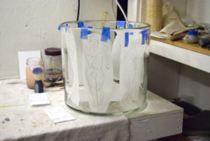 Emily Brown's imagery painted onto glass cylinder