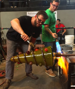 Two Glass artists shaping a large glass tree during Big Glass Blast.