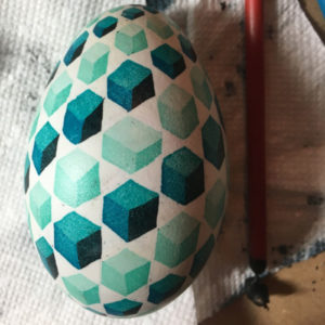 painted egg with teal box-like pattern