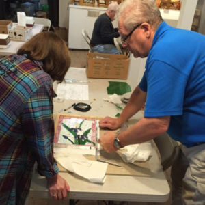 Dr. Paul Trivellini teaching a student how to create with stained glass