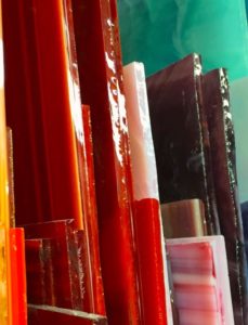 Slabs of red, white, and brown stained glass on a green background.