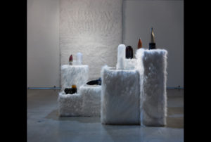 Several works by Fellow Heather Sutherland sitting on white faux fur pedestals.