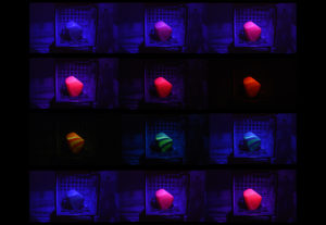 Video still boxes of twelve glass pieces shifting colors under an RGB LED bulb. Created by Evan Voelbel.