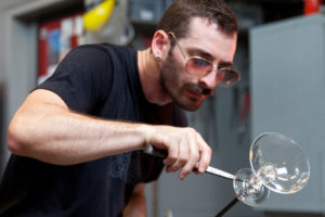 Medium shot of Alexander Rosenberg carefully creating a glass goblet