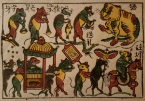 Dong Ho woodblock print of a Rat's Wedding with a large cat sitting and 12 rats playing instruments and carrying banners.