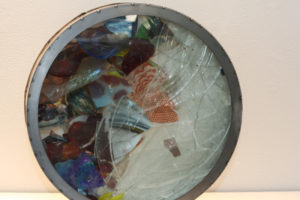 Drum with two individual object chambers, one containing clear plate glass and the other with colored cullet.