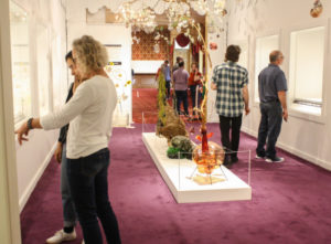 Visitors look through Jesse Krimes' installation “Strange Roots" for the Emanation 2019 exhibit in the Museum of American Glass at WheatonArts