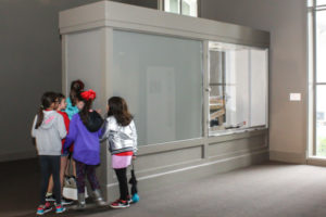 Children looking into the kaleidoscope.