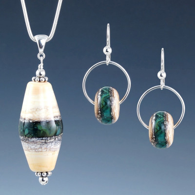 Matching white pendant and earrings with a deep peacock green bar through the centers