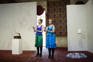 Martha McDonald and Laura Baird each run an index finger around the lip of their wine glass in hand, creating a soft hum for "Phantom Frequencies" at the Museum of American Glass