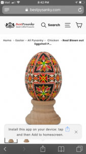 Pysanky by Marino Diaz with a strong black, white, yellow, and red geometric motif with triangle and rose patterns