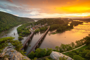 [sunset view above two bridges overlooking] Harpers Ferry, W.Va., sits at the confluence of the Potomac and Shenandoah Rivers. MarkVanDykePhotography/Shutterstock.com