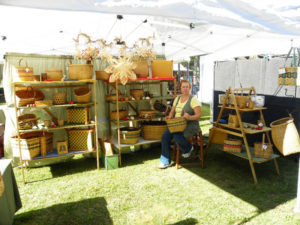 A booth showcasing the woven baskets of Mary May