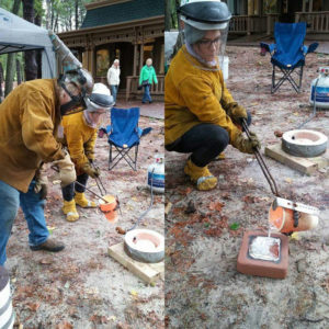 Rachel Marie Wenner and her mentor, Steve Morse, casting something in hot metal outside at WheatonArts