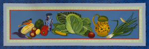 A painted floor cloth by Ellie Wyeth. a robin and goldfinch sit on either side of a pile of vegetables, including cabbage, tomatoes, and peppers.