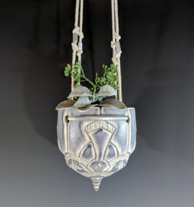 white and light blue ceramic plant hanger by Erika Novak and Drew Darley