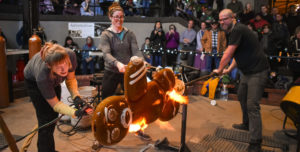 Three glassblowers from the Big Glass Blast team create a large scale gingerbread man at Big Glass Blast!