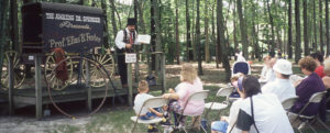 Medicine man entertaining guests from his outdoor stage at WheatonArts in 1995.