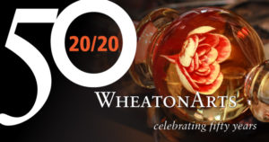 Banner for WheatonArts, celebrating fifty years. There is a large 50 on top with an orange 20/20 in the center, indication WheatonArts 50th anniversary in 2020.