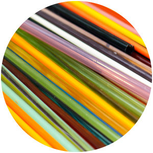 Circle cutout of colorful thin glass tubes.