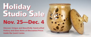 A long banner with "Holiday Studio Sale" in a large white font with a red outline, at the top left corner of the banner. Below that is "Nov. 25-Dec.4" in large red text. Below that is "Discover Unique and Beautifully Handcrafted Pottery and Glass Items at Discounted Prices Inside the Event Center. The background of the banner is grey and to the right of the text is a tan glazed jar with a large flower design. The lid of the jar is leaning on it's right side..