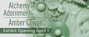 "Alchemy of Adornment: Amber Cowan - Exhibit Opening April 1" is displayed over a close-up of the detail on the Alchemy of Adornment exhibit artist Amber Cowan's glass sculpture is of a light green woman figure surrounded by pale green flowers.