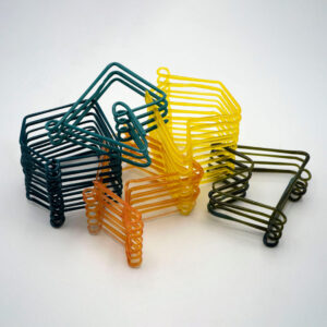 Image of artwork on a light gray background. The artwork is comprised of wire rack-shaped pieces stacked on top of each other and interlocked together. The wire on the left is dark blue and ten layers tall. It is interlocked with a six-layer orange piece. A two-layer blue green piece sits on top interlocked with a ten-layer yellow piece that is also interlocked with the orange piece. On the right, interlocked with the yellow piece, is a four-layer black piece.