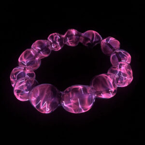 Image of a glass piece against a black background. The piece resembles a beaded bracelet where the beads are purple with a black wire holding them together. The purple appears to be lit up providing a electricity-like pattern throughout the piece.